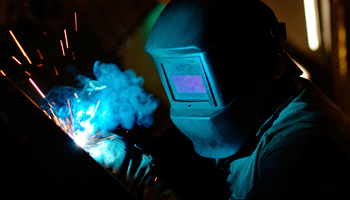 welder mask welding smoke close up metalworker metal